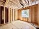 Bedroom under construction featuring wood framing, a window with a view, awaiting personalization at 1218 Kingwood Dr, Raleigh, NC 27609