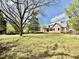 View of a house under construction, nestled in a tree lined lot ready for landscaping at 1218 Kingwood Dr, Raleigh, NC 27609