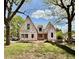 New home construction showcasing unique architectural details and wooded front yard under a partly cloudy sky at 1218 Kingwood Dr, Raleigh, NC 27609