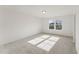 Well-lit bedroom with plush carpeting and a large window providing ample natural light at 1427 Goldsboro Ave, Sanford, NC 27330