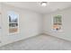 Bright bedroom features plush carpet, neutral walls, and natural light from two windows at 1427 Goldsboro Ave, Sanford, NC 27330