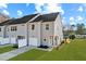 New construction townhome boasts a garage, yard, and contemporary gray siding at 1427 Goldsboro Ave, Sanford, NC 27330