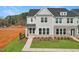 New two-story townhome with gray siding, brick accents, manicured lawn and front walkway at 1427 Goldsboro Ave, Sanford, NC 27330