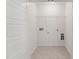 A convenient laundry room with tile flooring, a storage shelf and utility connections at 1427 Goldsboro Ave, Sanford, NC 27330