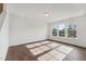 Bright living room with hardwood floors and large windows offering a view of the neighborhood at 1427 Goldsboro Ave, Sanford, NC 27330