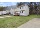 Two-story home with a wide lawn and mature trees offers a suburban retreat at 1431 Cherrycrest Dr, Durham, NC 27704