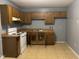 Kitchen featuring wooden cabinets, white appliances, and ample counter space at 1431 Cherrycrest Dr, Durham, NC 27704