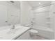 Bathroom with a white sink, toilet, and shower-tub combo at 1431 Goldsboro Ave, Sanford, NC 27330
