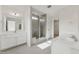 Bright bathroom with double vanity, tiled floors, and glass enclosed shower at 1431 Goldsboro Ave, Sanford, NC 27330