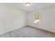 The carpeted bedroom has a window overlooking construction at 1431 Goldsboro Ave, Sanford, NC 27330