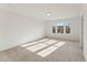 Bright bedroom featuring neutral carpet and three large windows at 1431 Goldsboro Ave, Sanford, NC 27330