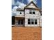 A close-up of the framing of a two-story home with many windows. New construction at 1431 Goldsboro Ave, Sanford, NC 27330