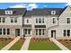 Modern townhomes featuring stone accents, neutral siding, and well-manicured lawns at 1431 Goldsboro Ave, Sanford, NC 27330
