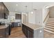 Modern kitchen with granite countertops, stainless steel appliances, and island seating at 1431 Goldsboro Ave, Sanford, NC 27330
