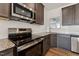 The kitchen is complete with stainless steel appliances and granite countertops at 1431 Goldsboro Ave, Sanford, NC 27330