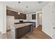 Stylish kitchen with granite island, stainless steel appliances, and dark cabinetry at 1431 Goldsboro Ave, Sanford, NC 27330