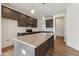 Well-lit kitchen features a granite island, dark wood cabinets, and stainless steel appliances at 1431 Goldsboro Ave, Sanford, NC 27330