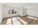 Sunlit living room features wood-look floors and ample windows for natural light at 1431 Goldsboro Ave, Sanford, NC 27330
