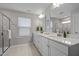 Bright bathroom featuring double vanity with quartz countertops, modern fixtures, and a tiled shower at 1726 Wimberly Rd, Apex, NC 27523