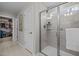 Bathroom featuring modern tiled shower with glass door, shelving, and linen closet at 1726 Wimberly Rd, Apex, NC 27523