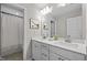 Bathroom featuring double vanity with quartz countertops, modern fixtures, and tiled flooring at 1726 Wimberly Rd, Apex, NC 27523