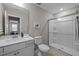 Modern bathroom features a walk-in shower, a vanity with sink, and clean, neutral decor at 1726 Wimberly Rd, Apex, NC 27523