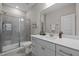 Bathroom with glass enclosed shower, vanity with white cabinets and modern fixtures at 1726 Wimberly Rd, Apex, NC 27523