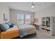 Bright bedroom featuring neutral walls, ceiling fan, with a work station and book shelves at 1726 Wimberly Rd, Apex, NC 27523