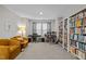 Spacious room with carpet, large bookcase, musical equipment, and comfortable seating at 1726 Wimberly Rd, Apex, NC 27523