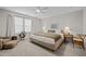 Bedroom with ceiling fan, neutral paint, carpet, and large windows providing natural light at 1726 Wimberly Rd, Apex, NC 27523