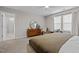 Neutral bedroom featuring a dresser, a chair, and windows with blinds at 1726 Wimberly Rd, Apex, NC 27523