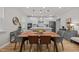 Dining area with a wooden table, modern chairs, and a view of the kitchen at 1726 Wimberly Rd, Apex, NC 27523