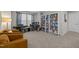 Cozy flex room with carpet, comfortable seating, piano, drum set, and bookshelf at 1726 Wimberly Rd, Apex, NC 27523