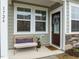Charming front porch featuring a bench, neutral colors, and a decorative wreath at 1726 Wimberly Rd, Apex, NC 27523