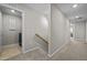 Upstairs hallway with carpet flooring and access to the laundry room at 1726 Wimberly Rd, Apex, NC 27523
