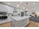 Bright kitchen featuring white cabinetry, stainless steel appliances, and pendant lighting at 1726 Wimberly Rd, Apex, NC 27523