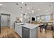 Open kitchen with stainless steel appliances, an island, and open to the dining area at 1726 Wimberly Rd, Apex, NC 27523