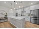 Modern kitchen with white cabinets, stainless steel appliances, and a large island at 1726 Wimberly Rd, Apex, NC 27523