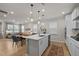 Open concept kitchen with island, pendant lights, stainless appliances and an eat-in dining area at 1726 Wimberly Rd, Apex, NC 27523