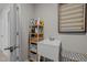 Functional laundry area with a utility sink, storage shelves, and space-saving drying rack at 1726 Wimberly Rd, Apex, NC 27523