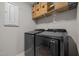 Well-organized laundry room with modern appliances and storage baskets on shelves at 1726 Wimberly Rd, Apex, NC 27523