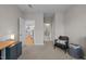 Cozy carpeted office space adjacent to a hallway with a view into the kitchen at 1726 Wimberly Rd, Apex, NC 27523