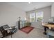 Well-lit office with carpet flooring, desk, a stylish cabinet and a comfortable chair at 1726 Wimberly Rd, Apex, NC 27523
