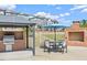 Community outdoor kitchen with grill, fireplace, and seating area, great for entertaining at 1726 Wimberly Rd, Apex, NC 27523