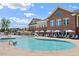 Resort-style pool with lounge chairs and umbrellas, perfect for relaxation and recreation at 1726 Wimberly Rd, Apex, NC 27523