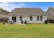 Inviting backyard with lush green lawn, patio seating area, perfect for relaxation and outdoor activities at 1728 Fern Hollow Trl, Wake Forest, NC 27587