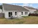 Cozy backyard with a dining set on a concrete patio and a well-maintained lawn, great for outdoor relaxation at 1728 Fern Hollow Trl, Wake Forest, NC 27587