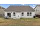 Well-maintained backyard with a dining set on a concrete patio, surrounded by a lush lawn at 1728 Fern Hollow Trl, Wake Forest, NC 27587