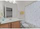 Bathroom with single vanity, neutral color scheme, and floral shower curtain, offering essential functionality at 1728 Fern Hollow Trl, Wake Forest, NC 27587