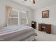 Bright bedroom with neutral walls and carpet, highlighting natural light and wooden desk area at 1728 Fern Hollow Trl, Wake Forest, NC 27587